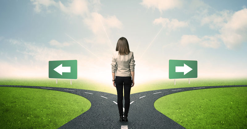 woman looking down 2 paths